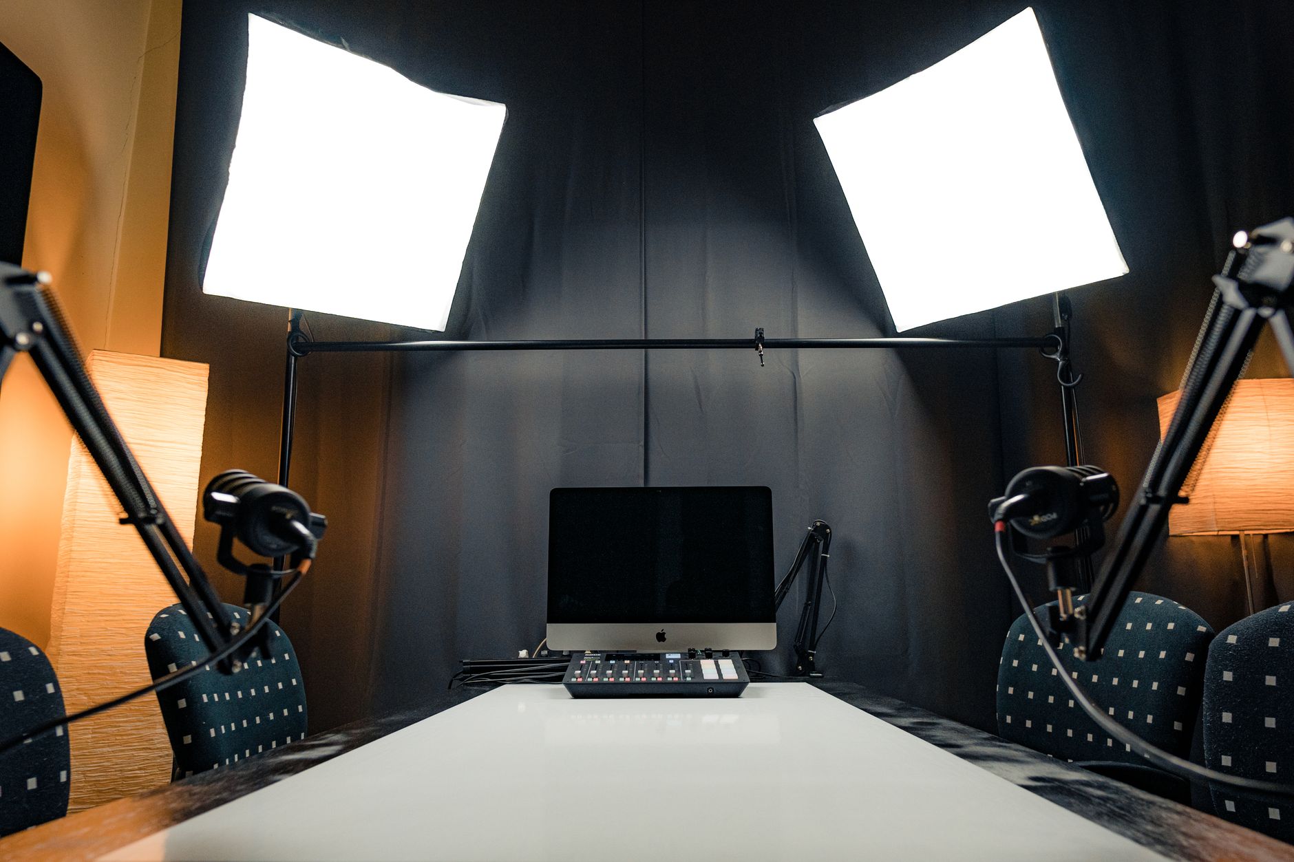 Interviewer sitting under dynamic studio lights